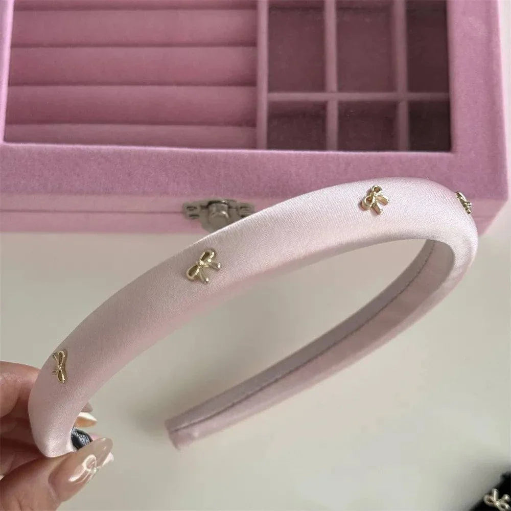 Pink cloth headband with gold alloy bow trims, 6.1 inch length, 5.5 inch width, lightweight design