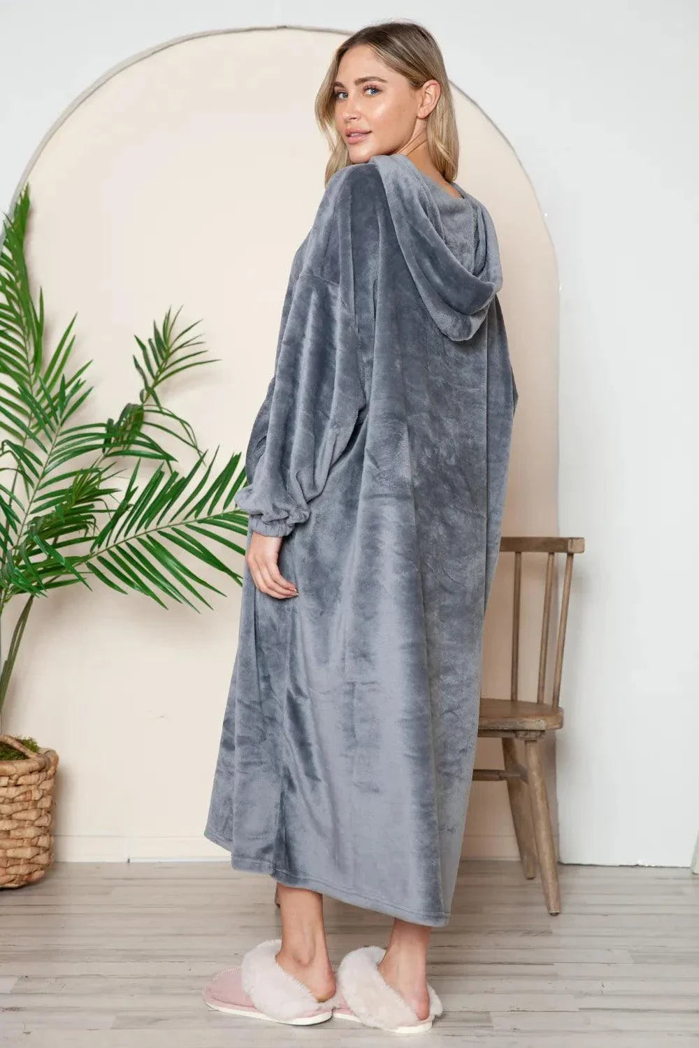 woman wearing gray hooded midi lounge dress with full pockets standing indoors