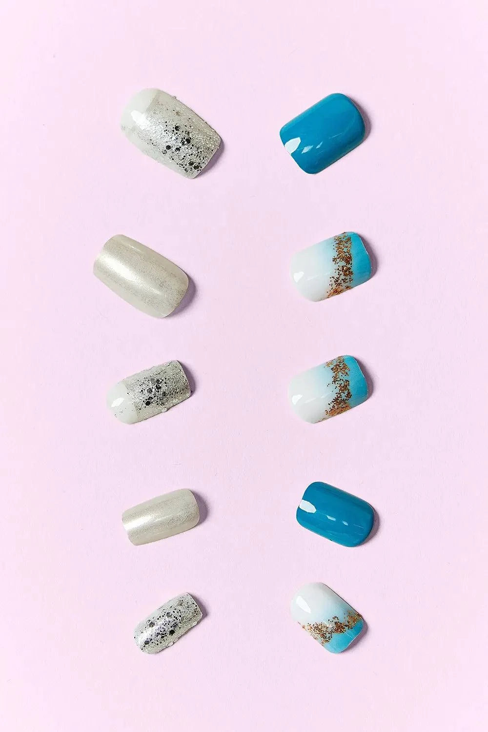 SO PINK BEAUTY press-on nails two packs with blue, white, silver, and glitter designs on pink background