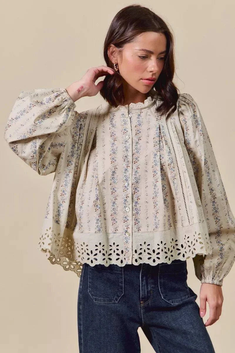 floral print lace button-down shirt with ruffled eyelet hem and long sleeves on model