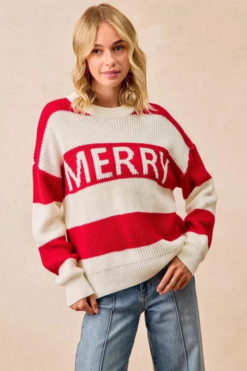 Woman wearing BiBi Christmas Merry Lettering Sweater with red and cream stripes and bold MERRY text.