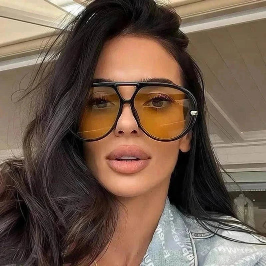 Woman wearing stylish aviator yellow tinted sunglasses with black frame