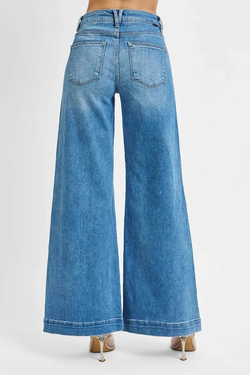 Back view of RISEN Plus Size Mid Rise Jeans with wide legs and patch pockets in blue denim