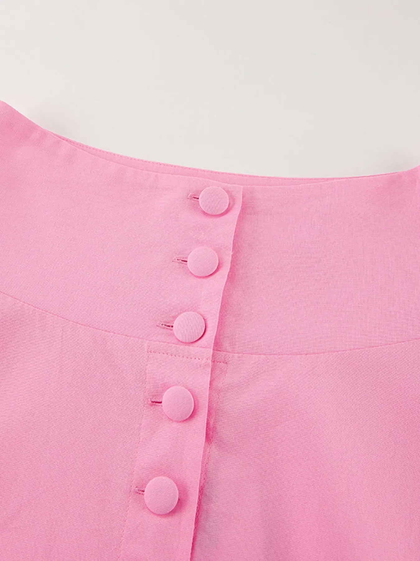 Pink short sleeve top with buttoned front made of 100% cotton, part of a two-piece skirt set