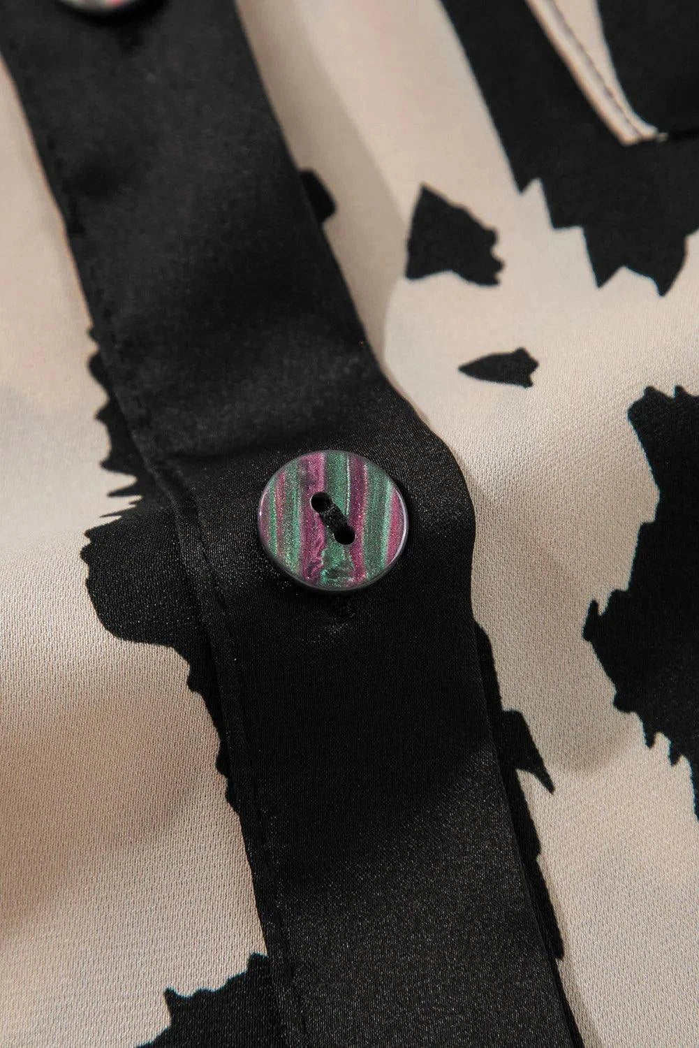 Button up long sleeve top with patterned fabric and detailed button closure