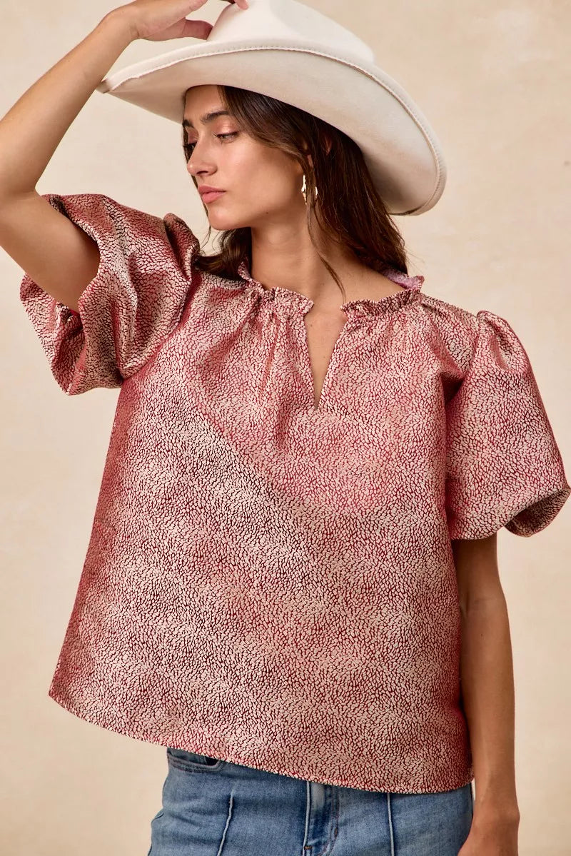 Woman wearing BiBi Jacquard woven short balloon sleeves V neck top in pink pattern with ruffled neckline and white hat