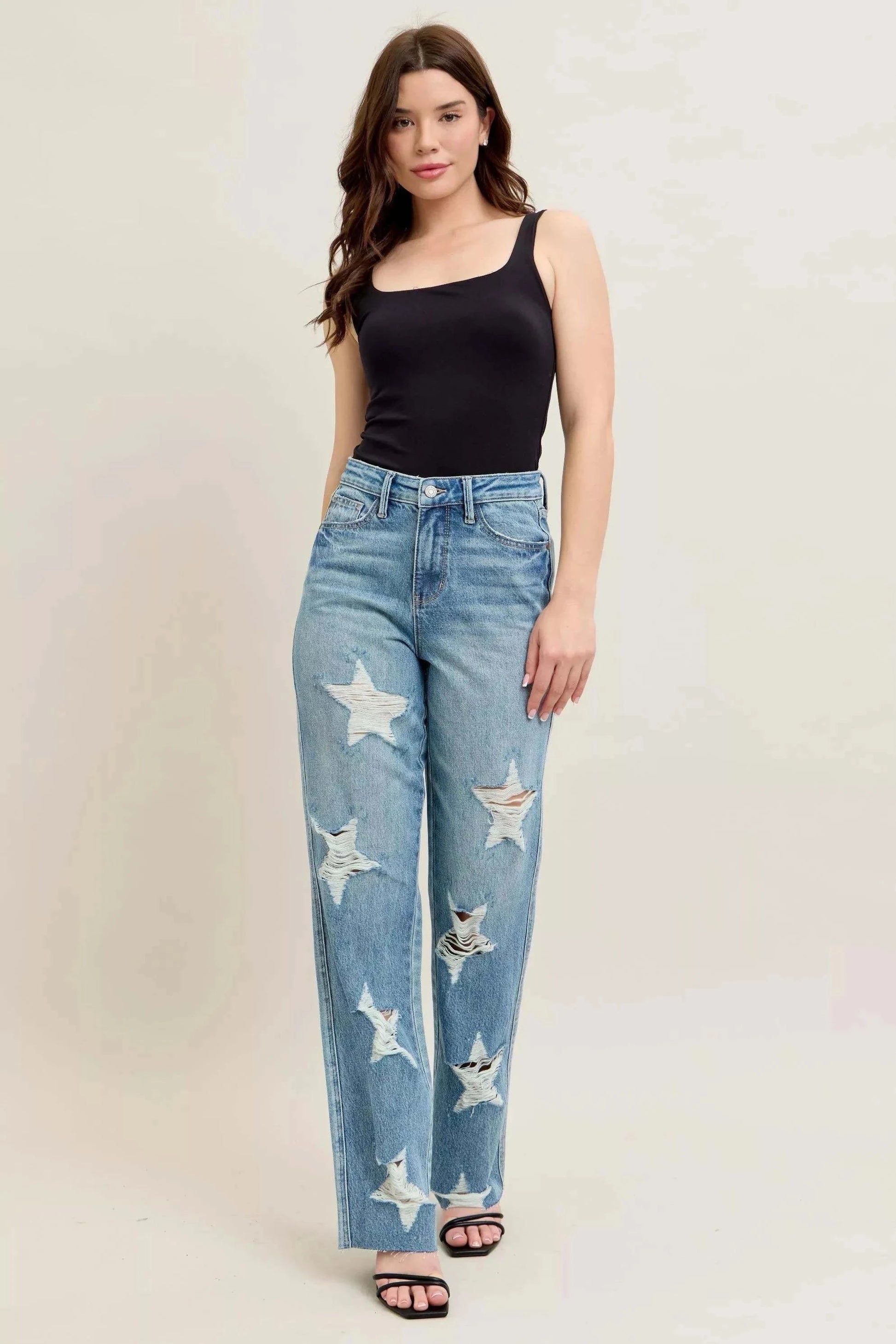 Judy Blue Plus Size 90's high waist straight jeans with star-shaped distressed details worn by woman in black tank top