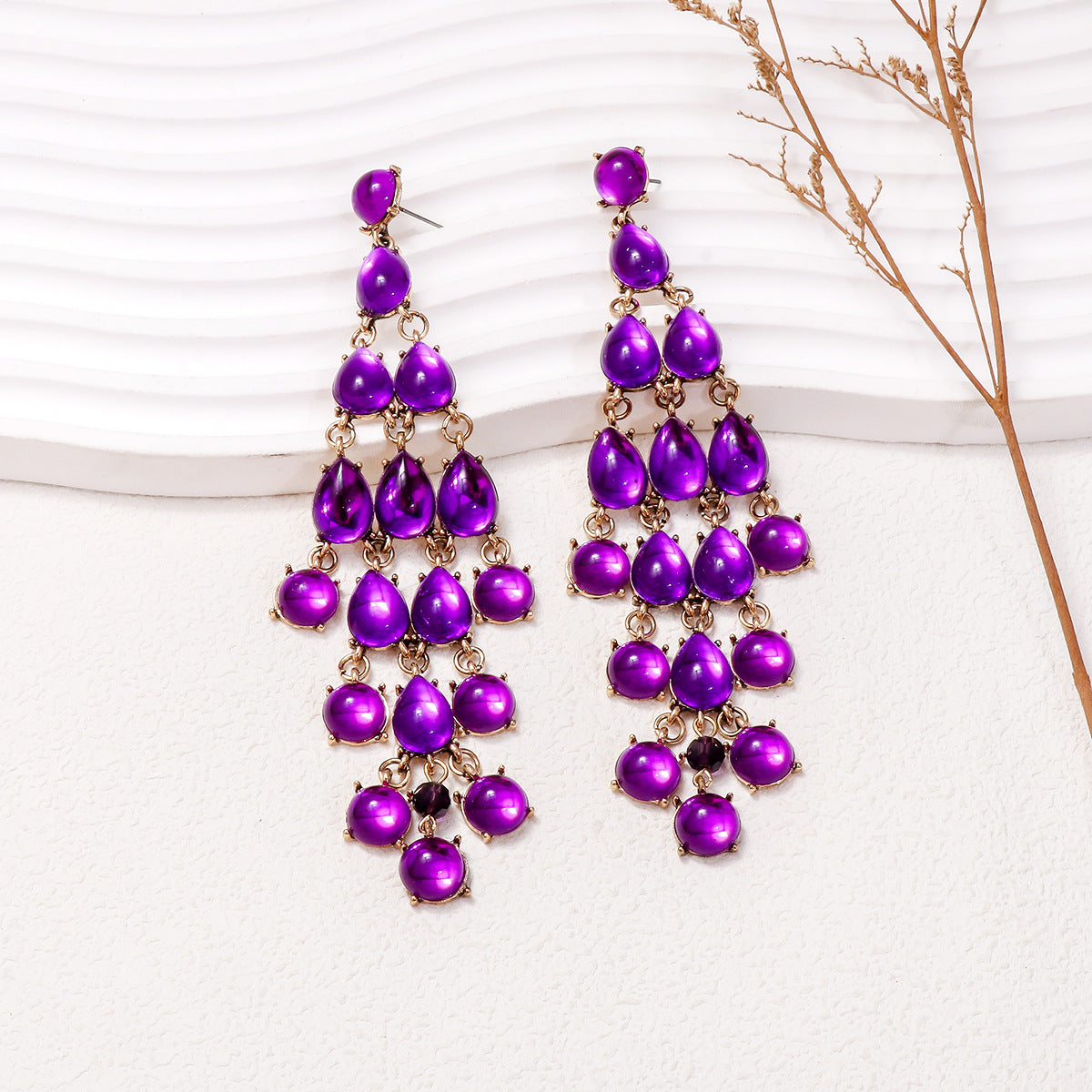 Alloy and rhinestone teardrop earrings with purple stones and gold-tone setting