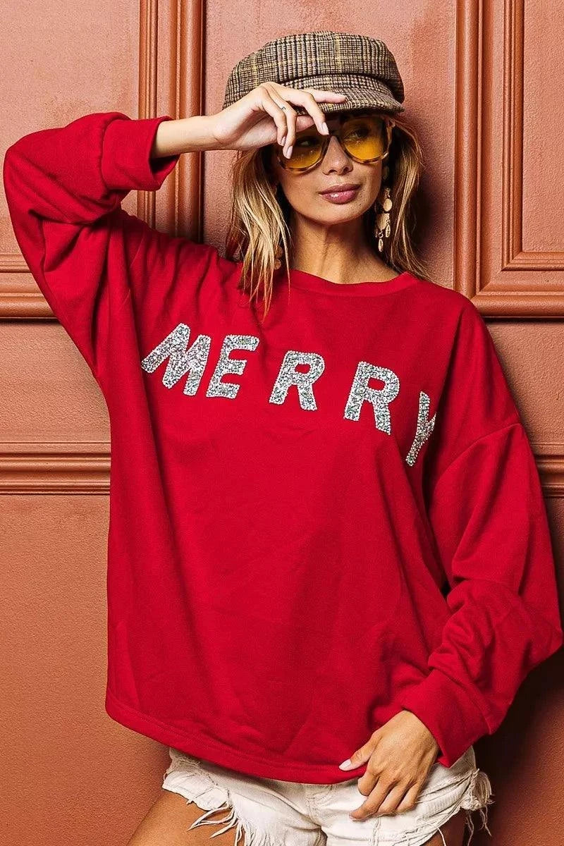 BiBi Merry Glitter Christmas Drop Shoulder TopThis Merry Glitter Christmas pullover is a festive and sparkly addition to your holiday wardrobe. The glitter detailing adds a touch of glamour and holiday cheer to BiBi Merry Glitter