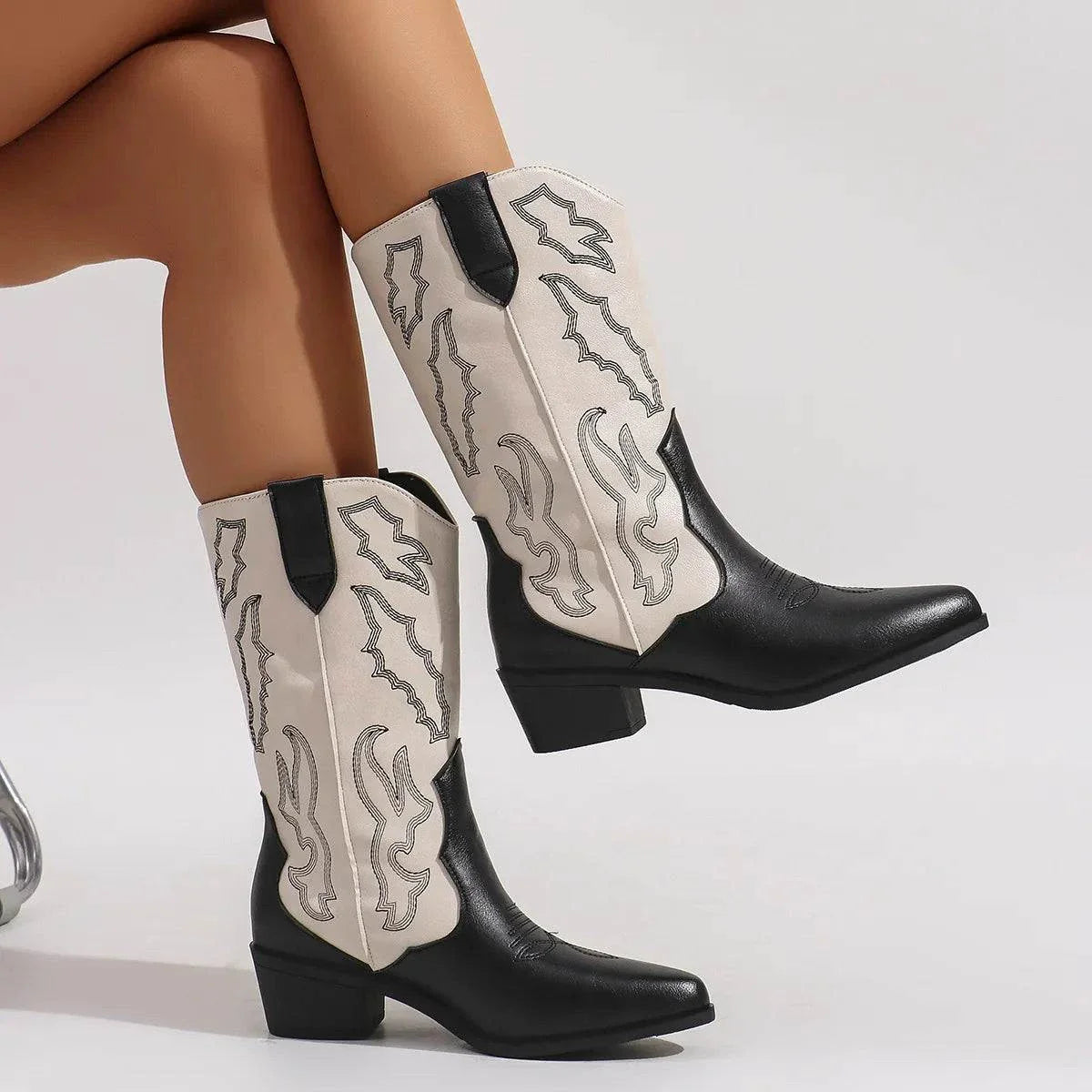 Black and white point toe block heels boots with mid-height heels and decorative stitching