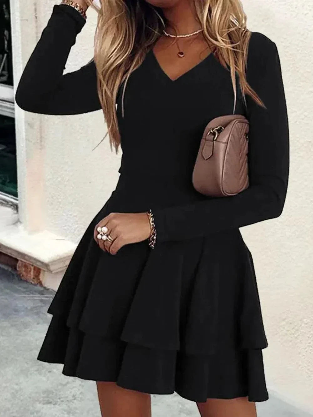 Plus size black V-neck mini dress with layered long sleeves and flared skirt