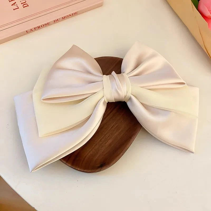 Elegant cream bow cloth hair clip made of cloth and alloy, measuring 10.2 x 7.3 inches